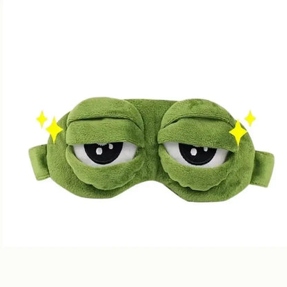 Frog Sleep Mask — A stylish, shimmering sleep mask featuring an adorable "Sad Frog" design. This fun, plush eye mask is perfect for travel, yoga, napping, and light-blocking; its soft cotton lining gently cares for sensitive skin.