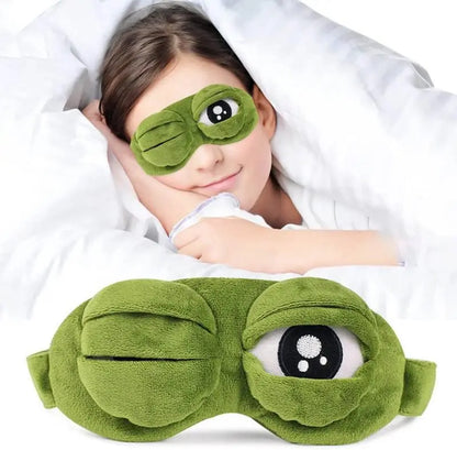 Frog Sleep Mask — A stylish, shimmering sleep mask featuring an adorable "Sad Frog" design. This fun, plush eye mask is perfect for travel, yoga, napping, and light-blocking; its soft cotton lining gently cares for sensitive skin.