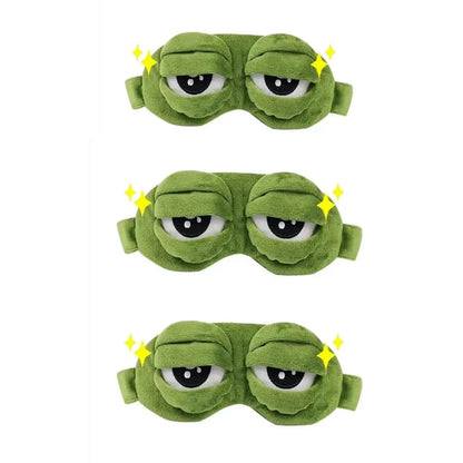 Frog Sleep Mask — A stylish, shimmering sleep mask featuring an adorable "Sad Frog" design. This fun, plush eye mask is perfect for travel, yoga, napping, and light-blocking; its soft cotton lining gently cares for sensitive skin.
