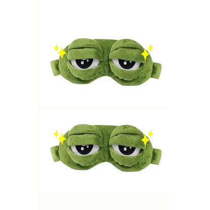 Frog Sleep Mask — A stylish, shimmering sleep mask featuring an adorable "Sad Frog" design. This fun, plush eye mask is perfect for travel, yoga, napping, and light-blocking; its soft cotton lining gently cares for sensitive skin.